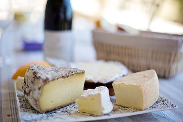 plate of cheese with wine bottle